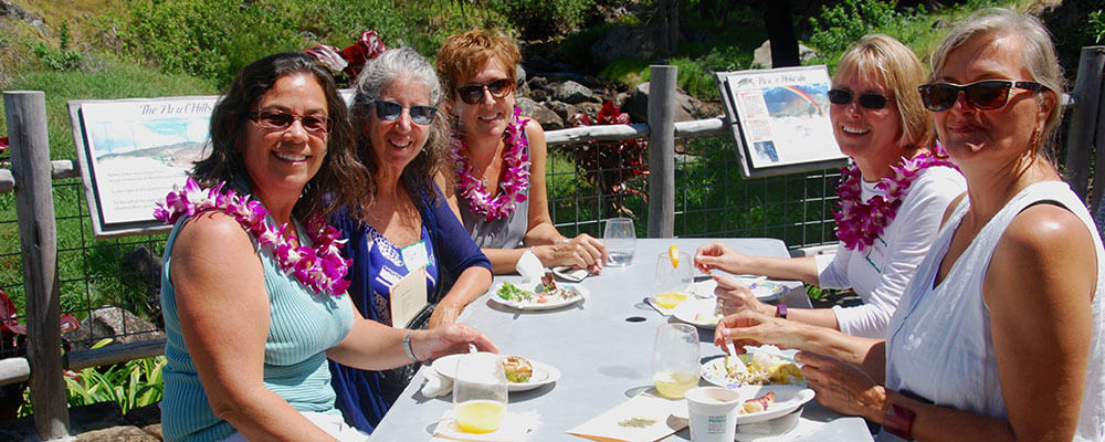 hospice volunteers sharing a meal at an outdoor potluck